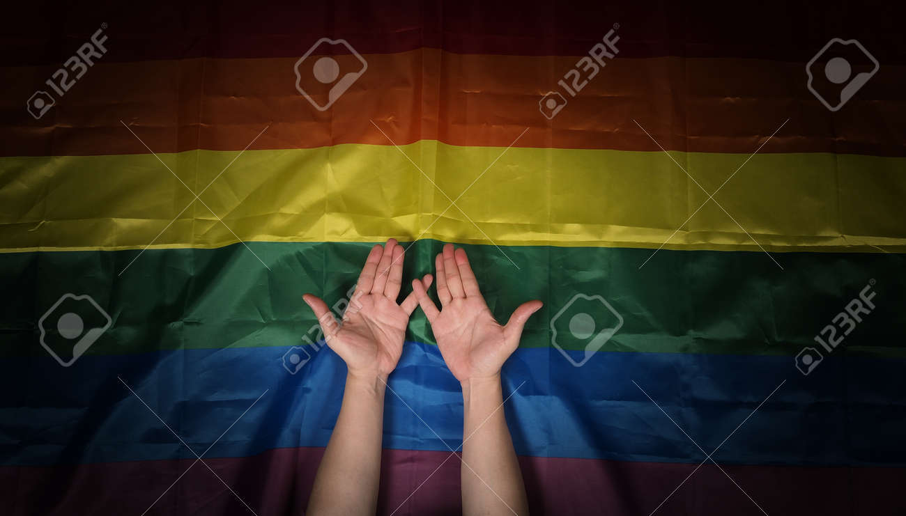 LGBTQ pride flag. Lesbian Gay Bi sexsual Transgender Queer. Homosexsual pride Rainbow flag in hand. black background. Represent symbol of freedom, peace, equality and love. LGBTQ concept. - 169136577 LGBTQ pride flag. Lesbian Gay Bi sexsual Transgender Queer. Homosexsual pride Rainbow flag in hand. black background. Represent symbol of freedom, peace, equality and love. LGBTQ concept. - 169136577