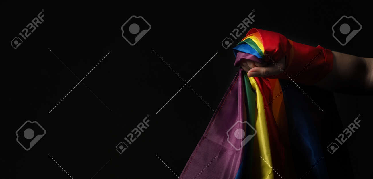 LGBTQ pride flag. Lesbian Gay Bi sexsual Transgender Queer. Homosexsual pride Rainbow flag in hand. black background. Represent symbol of freedom, peace, equality and love. LGBTQ concept. - 169136628 LGBTQ pride flag. Lesbian Gay Bi sexsual Transgender Queer. Homosexsual pride Rainbow flag in hand. black background. Represent symbol of freedom, peace, equality and love. LGBTQ concept. - 169136628