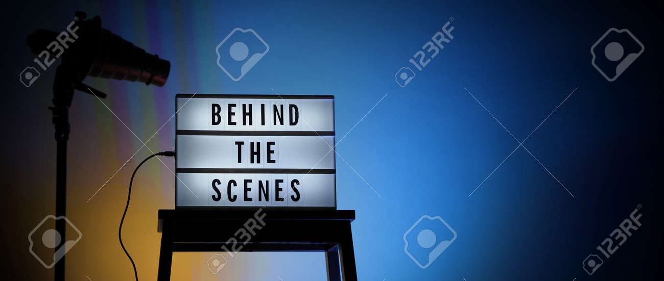 Behind the scenes letterboard text on Lightbox or Cinema Light box. Movie clapperboard megaphone and director chair beside. Background LED color change loop. static camera in video production studio. - 170416168 Behind the scenes letterboard text on Lightbox or Cinema Light box. Movie clapperboard megaphone and director chair beside. Background LED color change loop. static camera in video production studio. - 170416168