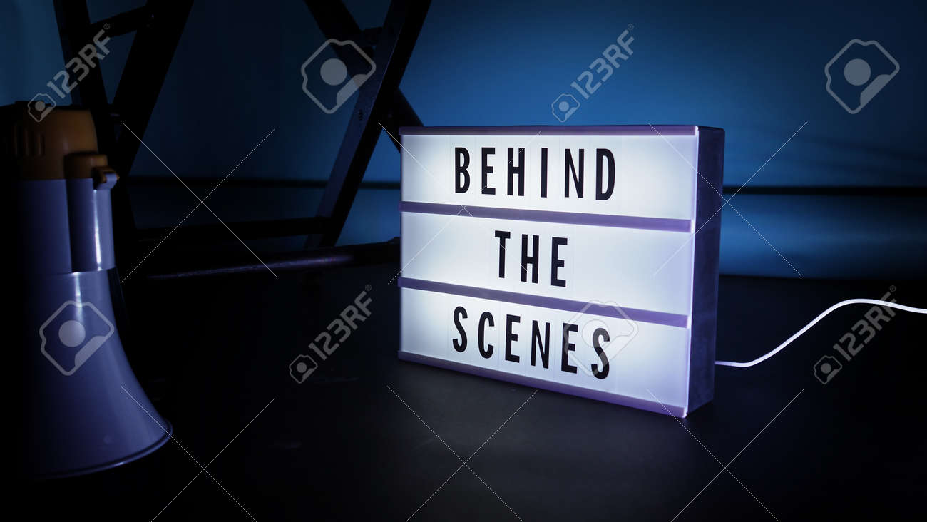 Behind the scenes letterboard text on Lightbox or Cinema Light box. Movie clapperboard megaphone and director chair beside. Background LED color change loop. static camera in video production studio. - 170416172 Behind the scenes letterboard text on Lightbox or Cinema Light box. Movie clapperboard megaphone and director chair beside. Background LED color change loop. static camera in video production studio. - 170416172