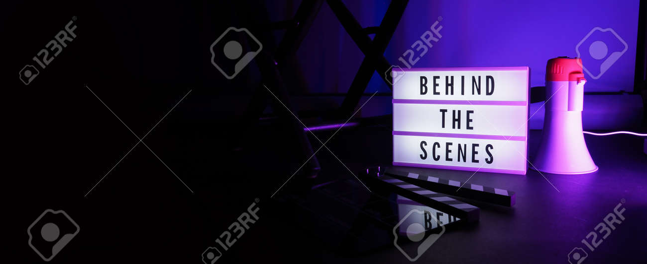 Behind the scenes letterboard text on Lightbox or Cinema Light box. Movie clapperboard megaphone and director chair beside. Background LED color change loop. static camera in video production studio. - 170416182 Behind the scenes letterboard text on Lightbox or Cinema Light box. Movie clapperboard megaphone and director chair beside. Background LED color change loop. static camera in video production studio. - 170416182