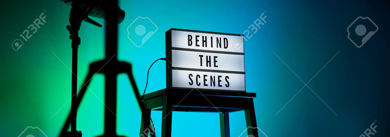 Behind the scenes letterboard text on Lightbox or Cinema Light box. Movie clapperboard megaphone and director chair beside. Background LED color change loop. static camera in video production studio. - 170416183 Behind the scenes letterboard text on Lightbox or Cinema Light box. Movie clapperboard megaphone and director chair beside. Background LED color change loop. static camera in video production studio. - 170416183
