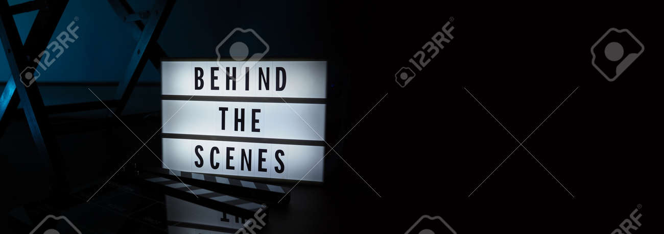 Behind the scenes letterboard text on Lightbox or Cinema Light box. Movie clapperboard megaphone and director chair beside. Background LED color change loop. static camera in video production studio. - 170416187 Behind the scenes letterboard text on Lightbox or Cinema Light box. Movie clapperboard megaphone and director chair beside. Background LED color change loop. static camera in video production studio. - 170416187