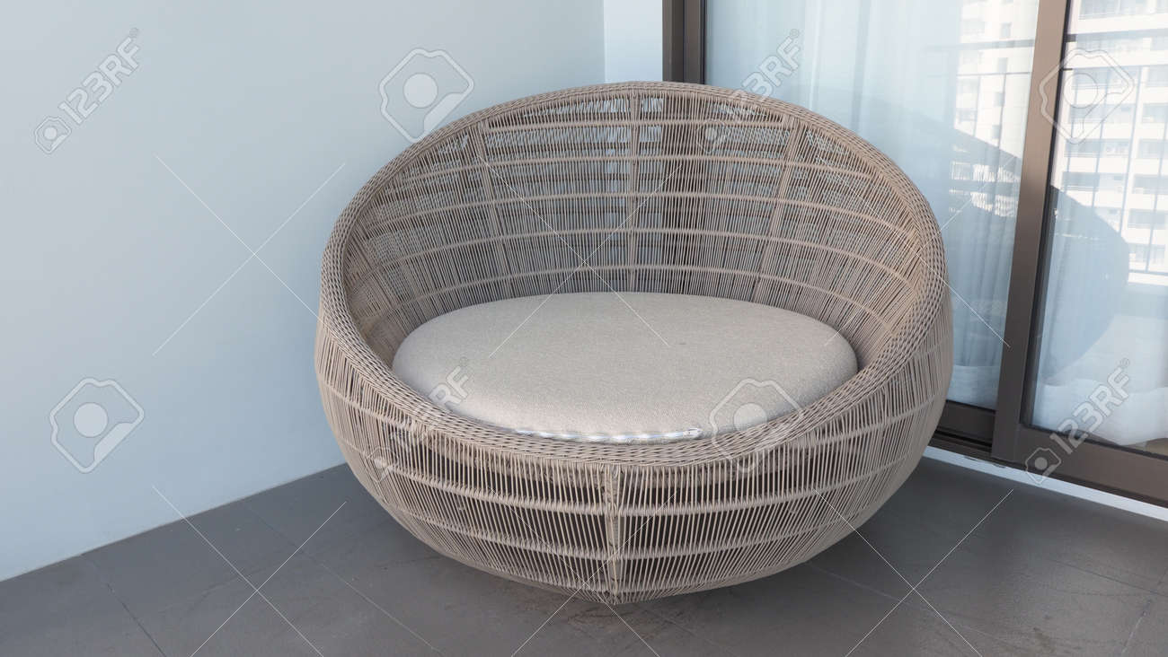Outdoor beach chair on the hotel room balcony or terrace which made from natural wood called rattan and brown color round shape and look luxury for relaxing or sleeping or for party. - 170835224 Outdoor beach chair on the hotel room balcony or terrace which made from natural wood called rattan and brown color round shape and look luxury for relaxing or sleeping or for party. - 170835224