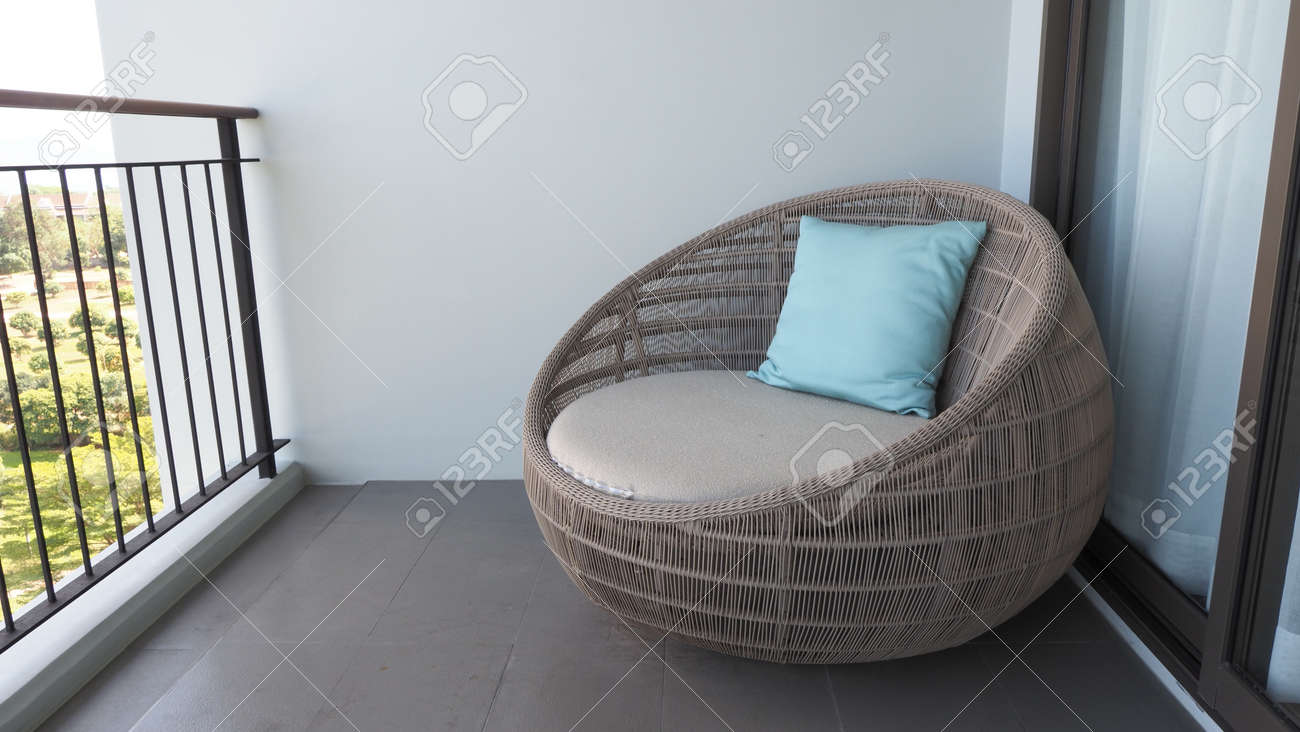Outdoor beach chair on the hotel room balcony or terrace which made from natural wood called rattan and brown color round shape and look luxury for relaxing or sleeping or for party. - 170835152 Outdoor beach chair on the hotel room balcony or terrace which made from natural wood called rattan and brown color round shape and look luxury for relaxing or sleeping or for party. - 170835152