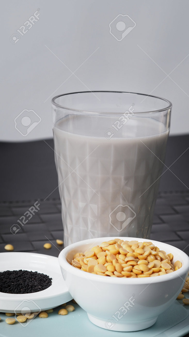 Soy milk blended with black sesame in clear glass on black plate mat. Black sesame seed and soy beans in a cup. Black sesame soy bean blended milk. Healthy drink with natural ingrediant. Soya milk. - 171239770 Soy milk blended with black sesame in clear glass on black plate mat. Black sesame seed and soy beans in a cup. Black sesame soy bean blended milk. Healthy drink with natural ingrediant. Soya milk. - 171239770