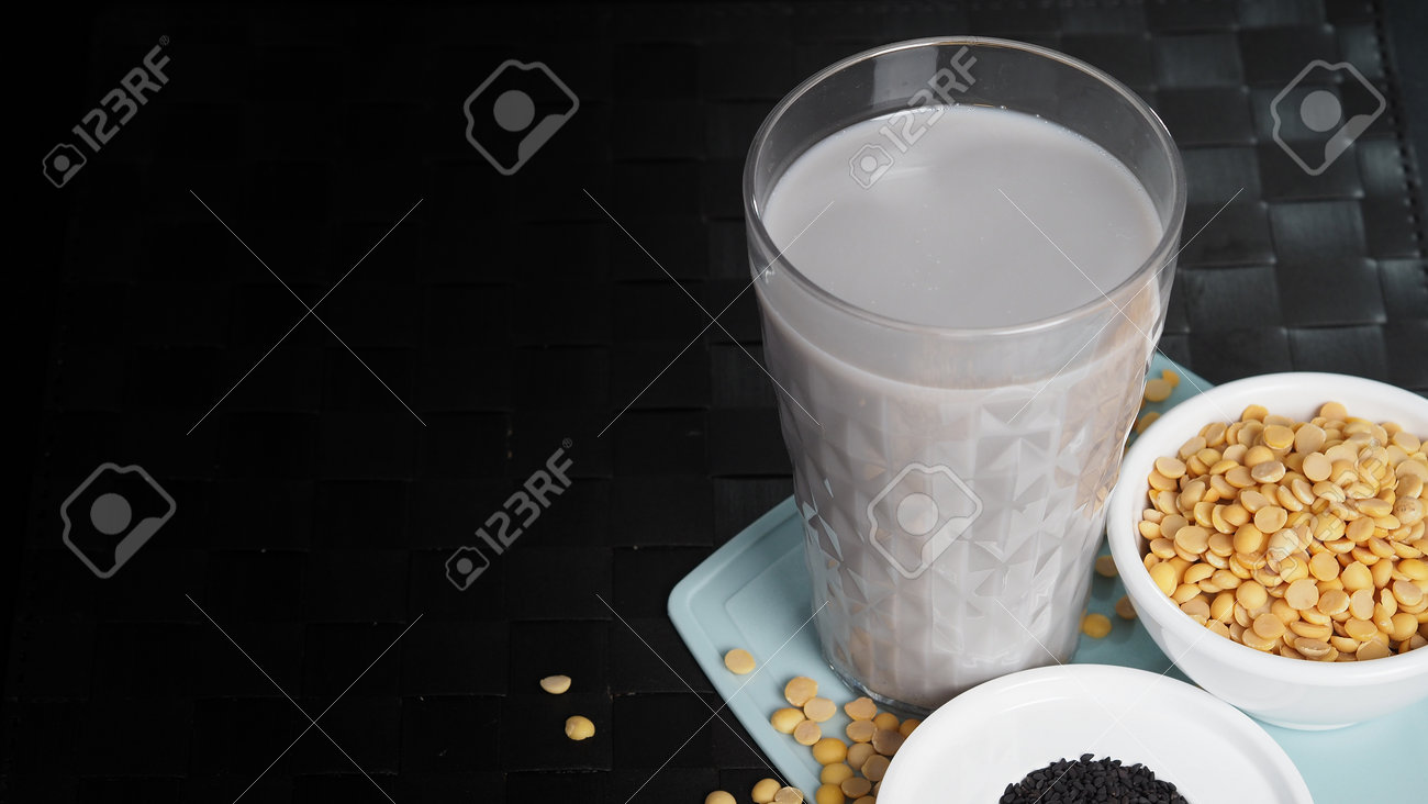 Soy milk blended with black sesame in clear glass on black plate mat. Black sesame seed and soy beans in a cup. Black sesame soy bean blended milk. Healthy drink with natural ingrediant. Soya milk. - 171239774 Soy milk blended with black sesame in clear glass on black plate mat. Black sesame seed and soy beans in a cup. Black sesame soy bean blended milk. Healthy drink with natural ingrediant. Soya milk. - 171239774
