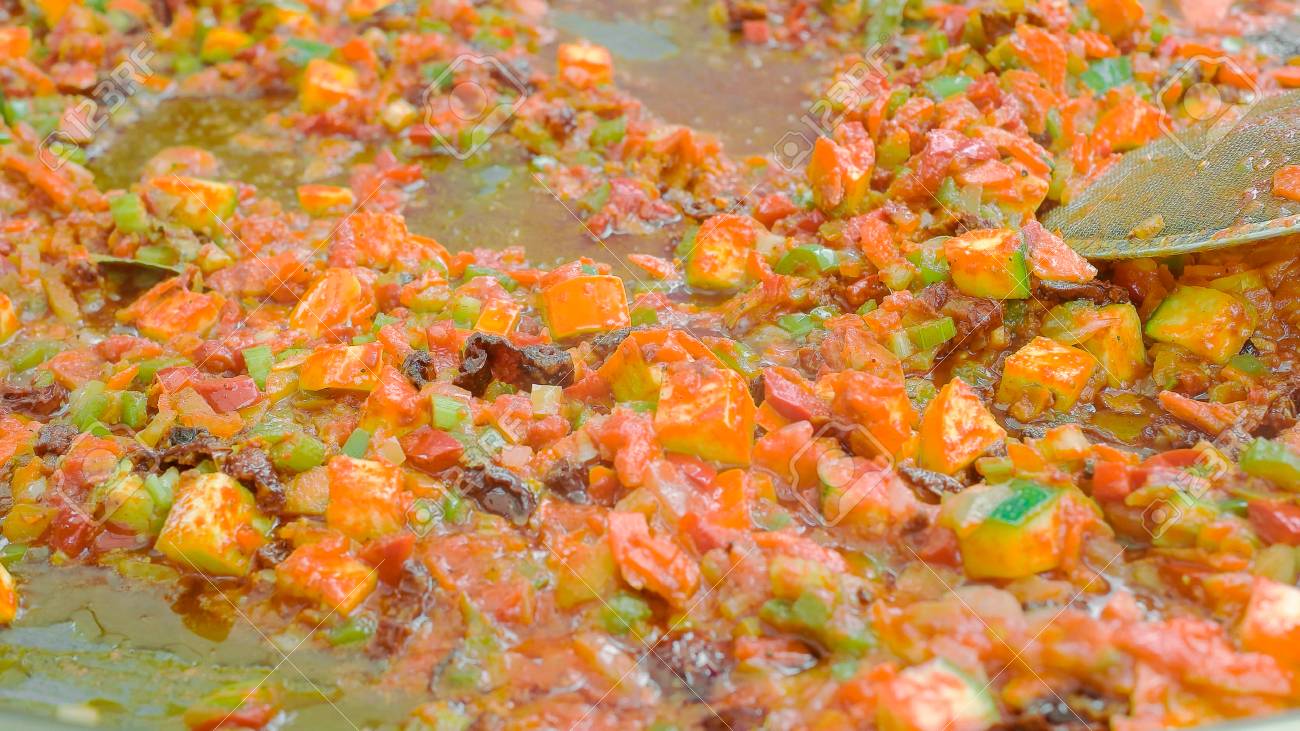 Close up shot of vegetarian food being cooked on huge pan - 56219598 Close up shot of vegetarian food being cooked on huge pan - 56219598