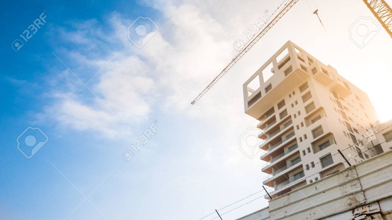 One building reaching to the sky being developed and finished up - 58641317 One building reaching to the sky being developed and finished up - 58641317