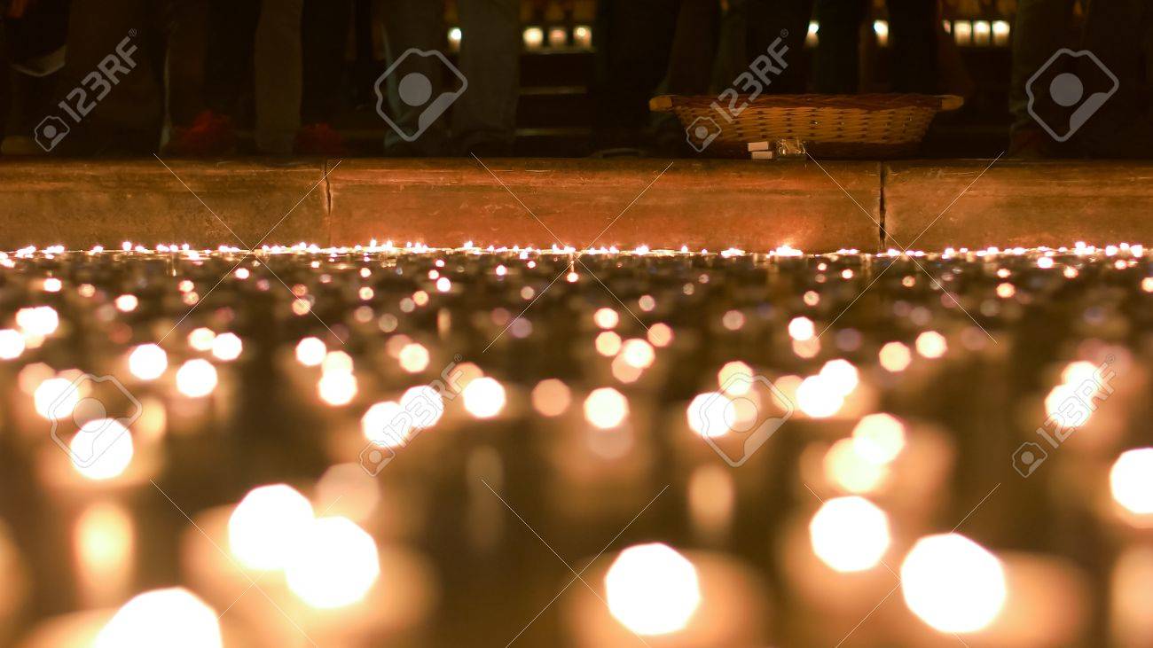 Candles lit by people burning in front of the church podium - 60533724 Candles lit by people burning in front of the church podium - 60533724