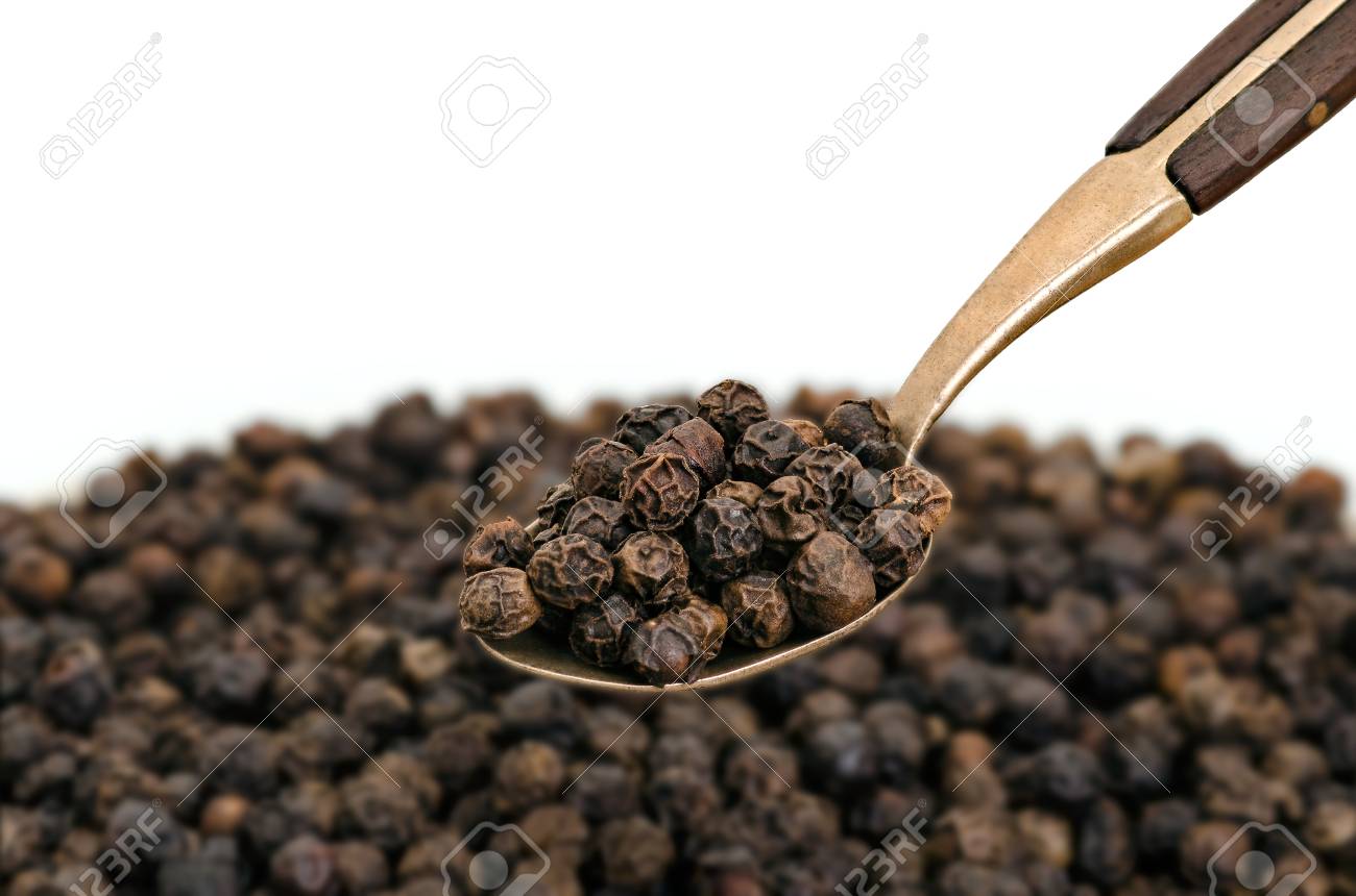 Whole Black Pepper on Old Spoon - 69898499 Whole Black Pepper on Old Spoon - 69898499