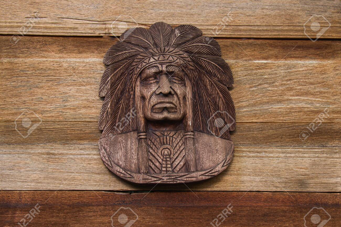 Red Indian Head Carved With Wood Hang On The Brown Wooden Wall Stock Photo Picture And Royalty Free Image Image