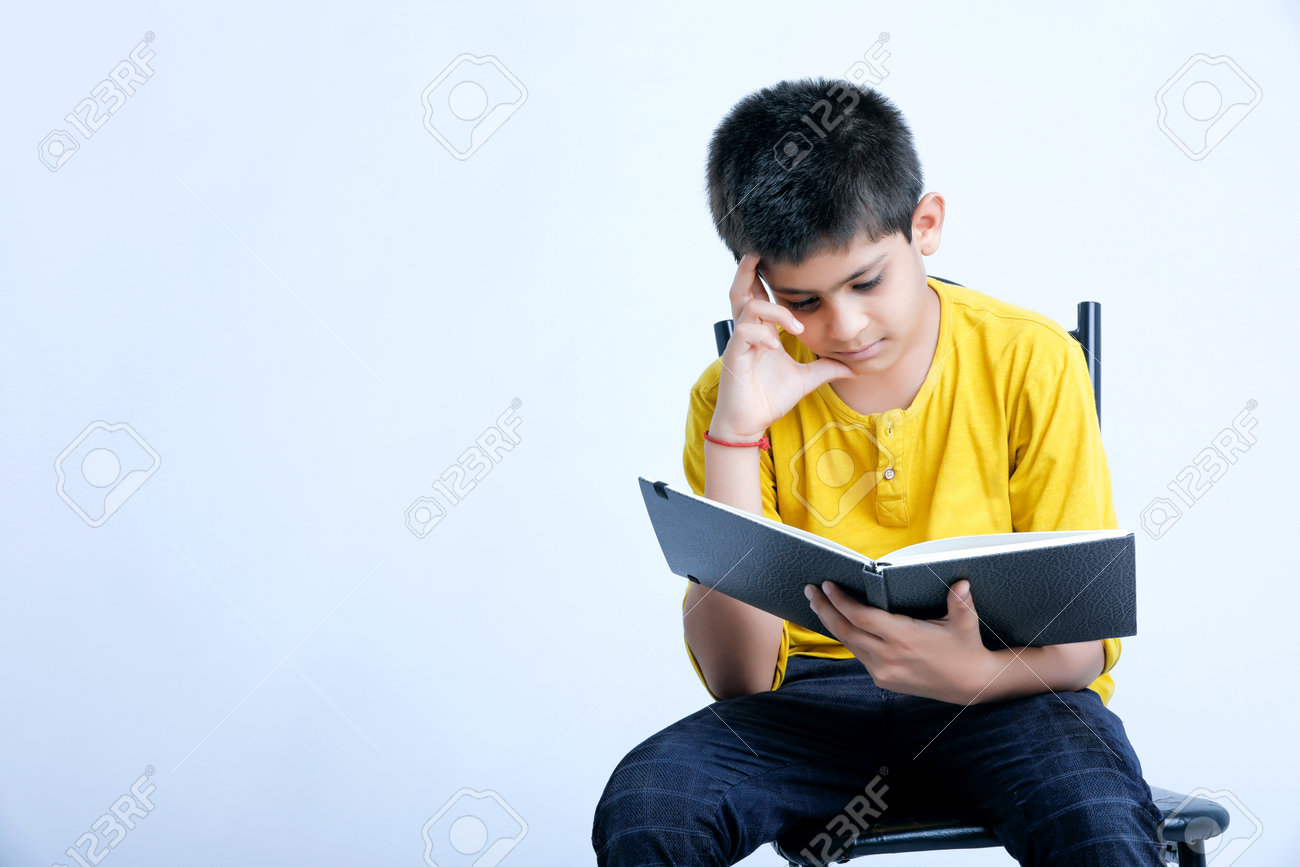 Young Indian Cute Child Reading A Book Stock Photo, Picture and Royalty  Free Image. Image 164479237., image size:1300x867