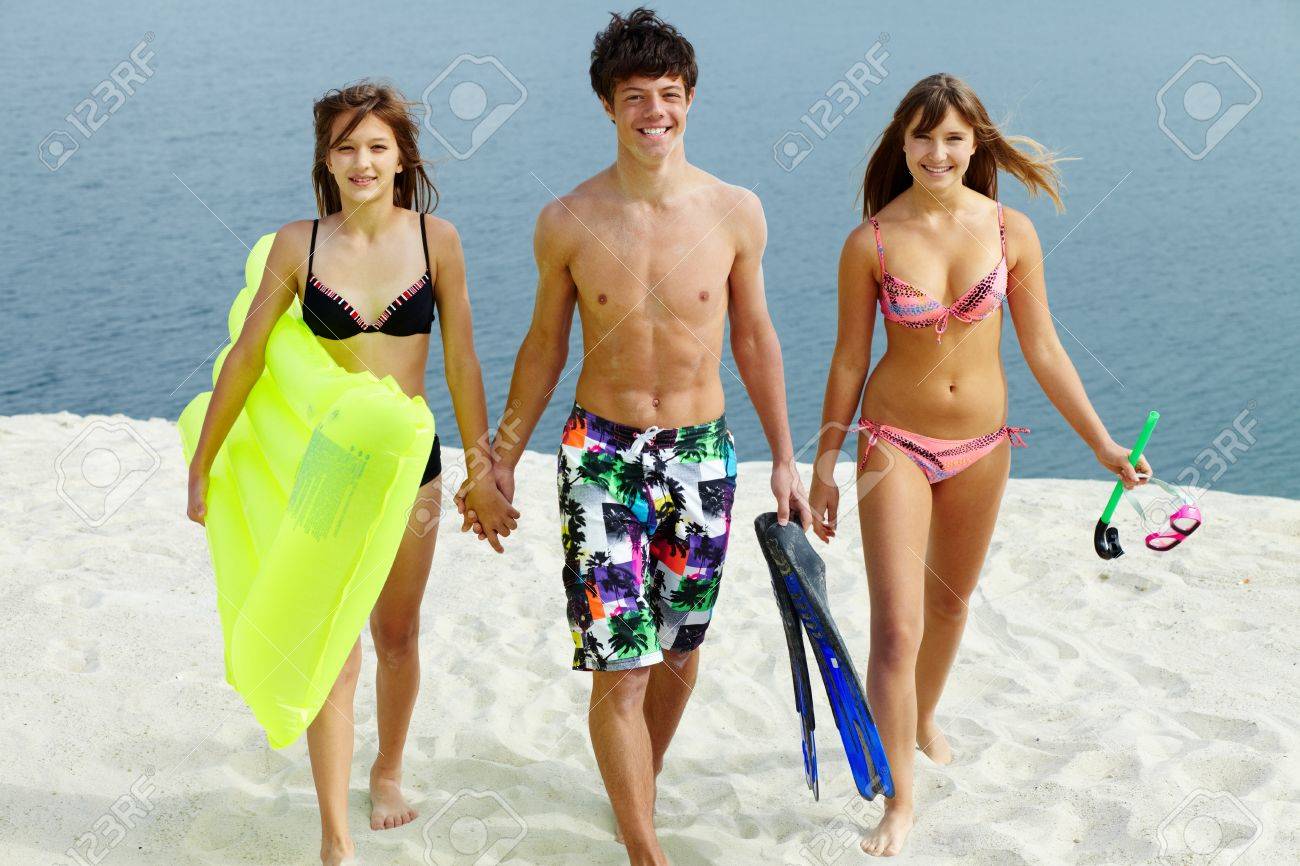 girl and two guys at the beach