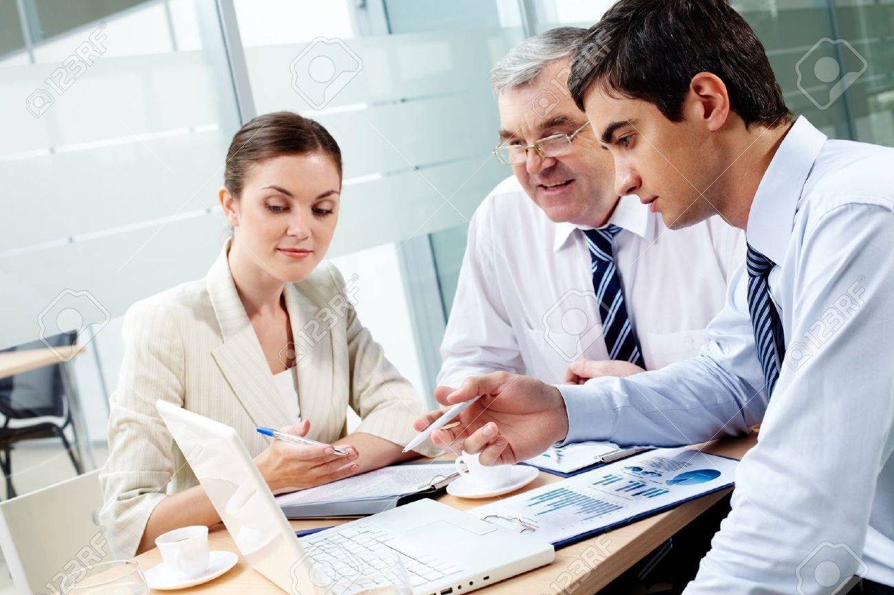 A business team of three sitting in office and planning work - 12061644 A business team of three sitting in office and planning work - 12061644