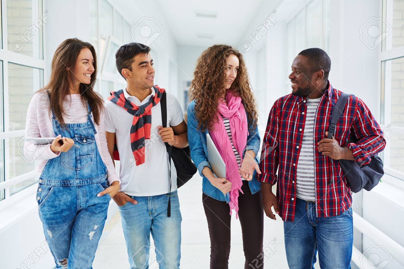 modern teens of various ethnicities talking in college corridor teens collage