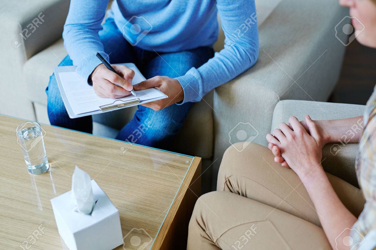 Male psychologist making notes during psychological therapy - 53768792 Male psychologist making notes during psychological therapy - 53768792