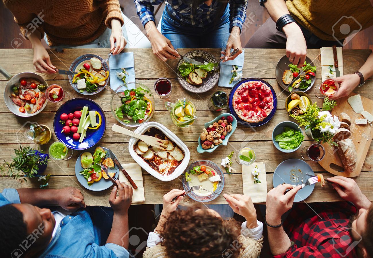 Group of young people eating dinner - 54993876 Group of young people eating dinner - 54993876