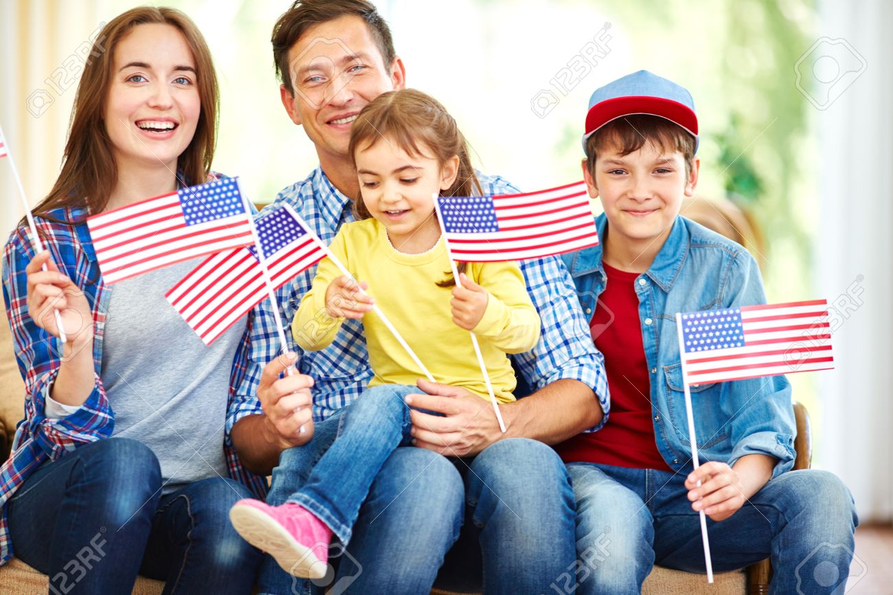 Happy family with flags of usa celebrating independence day stock photo 54993917