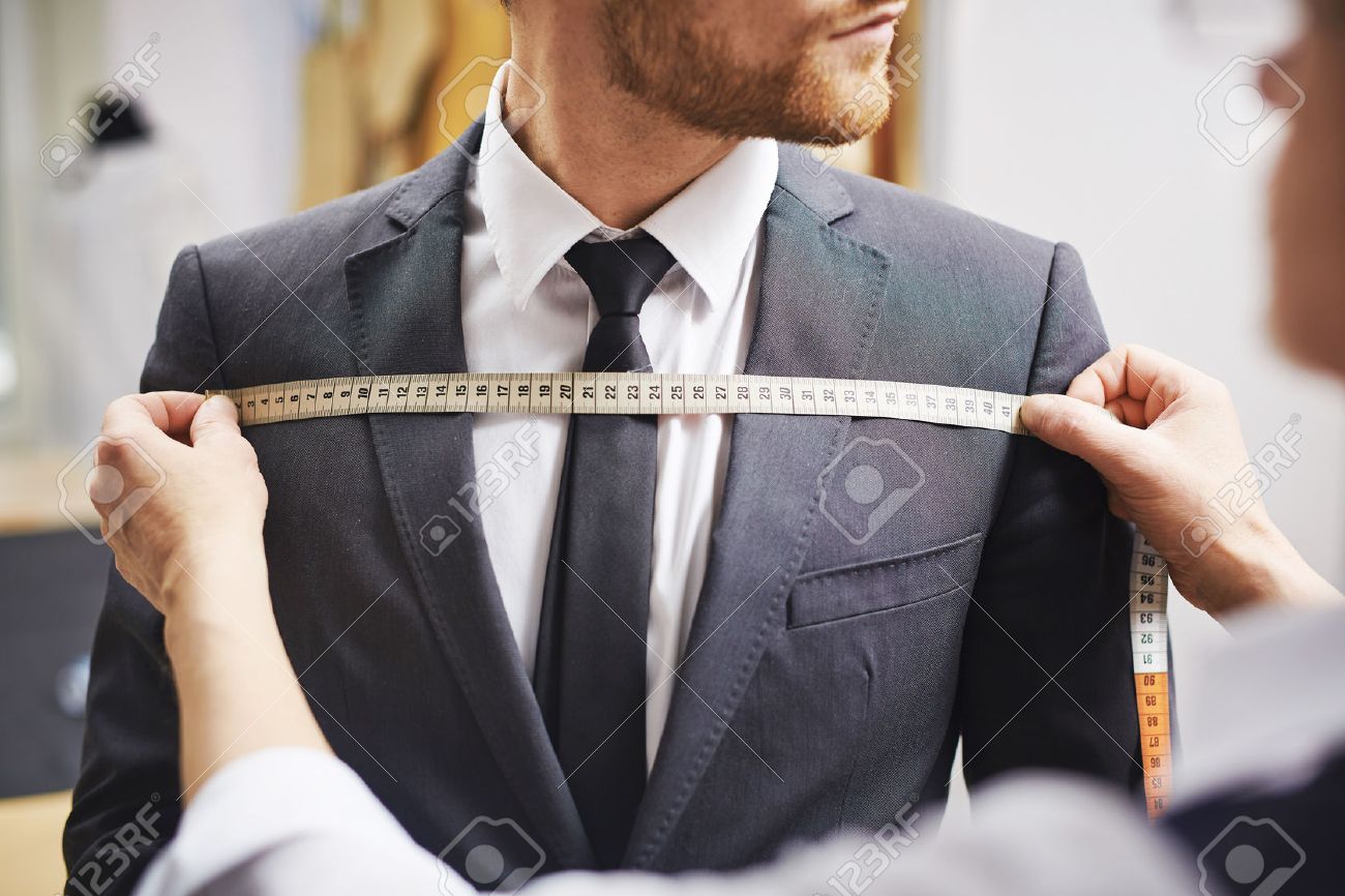 Tailor measuring front of businessman jacket - 58463490 Tailor measuring front of businessman jacket - 58463490
