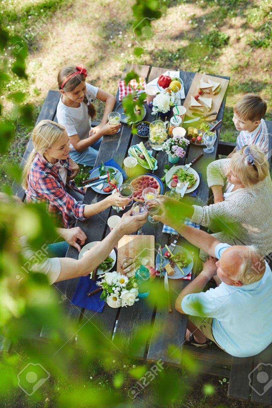 Big happy family with kids and grandparents having healthy tasty bbq lunch outdoors - 61255002 Big happy family with kids and grandparents having healthy tasty bbq lunch outdoors - 61255002