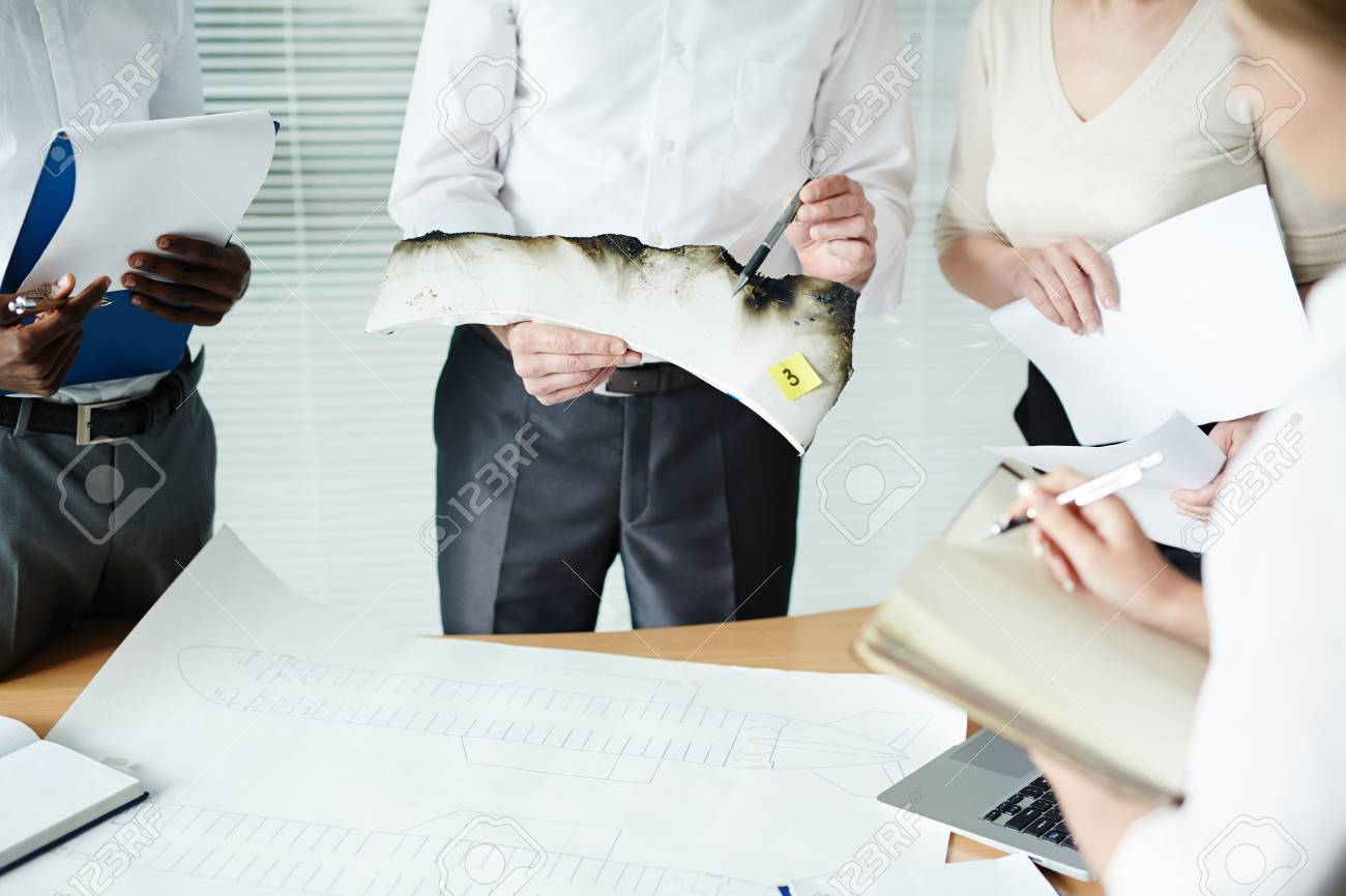 highly professional forensic examiner pointing at burnt edge stock forensic examiner