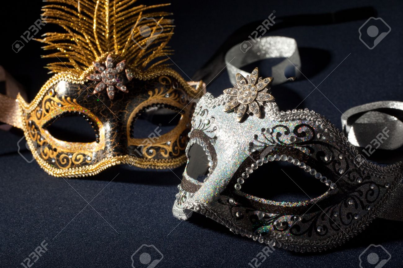 silver and black carnival masks isolated on a black background stock