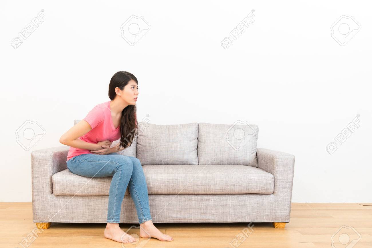 uncomfortable couch floral stock photo young woman sitting on couch sofa making stomach pain gesture and feeling uncomfortable in the wooden floor with white background young woman sitting on couch sofa making stomach pain gesture uncomfortable couch floral stock photo young woman sitting on couch sofa making stomach pain gesture and feeling uncomfortable in the wooden floor with white background young woman sitting on couch sofa making stomach pain gesture