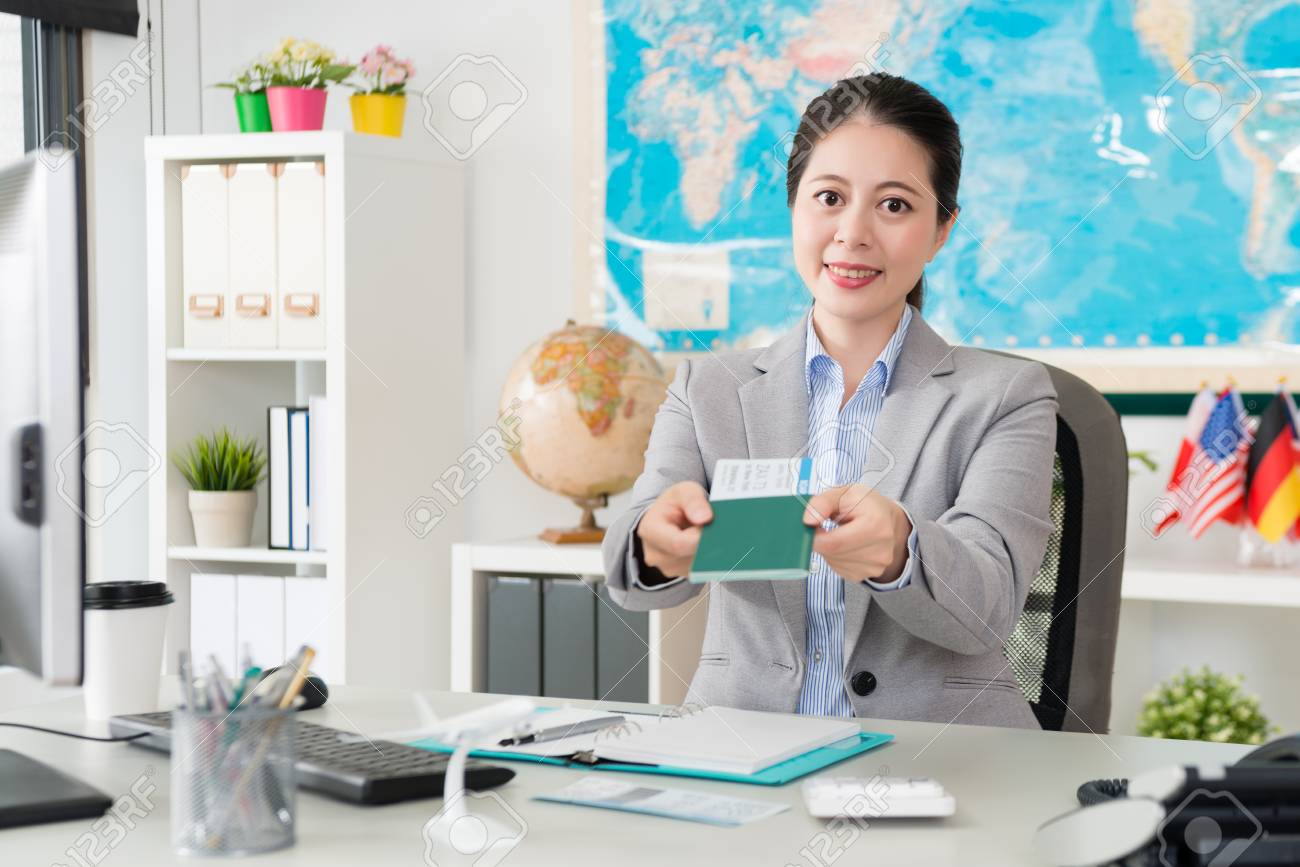 beautiful pretty female travel agent company office worker holding airline agent