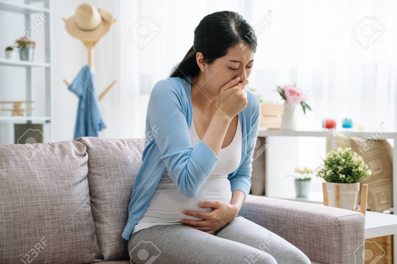 Sick Young Pregnant Asian Woman Sitting On Couch Suffering With Stock Photo Picture And Royalty Free Image Image 122715849