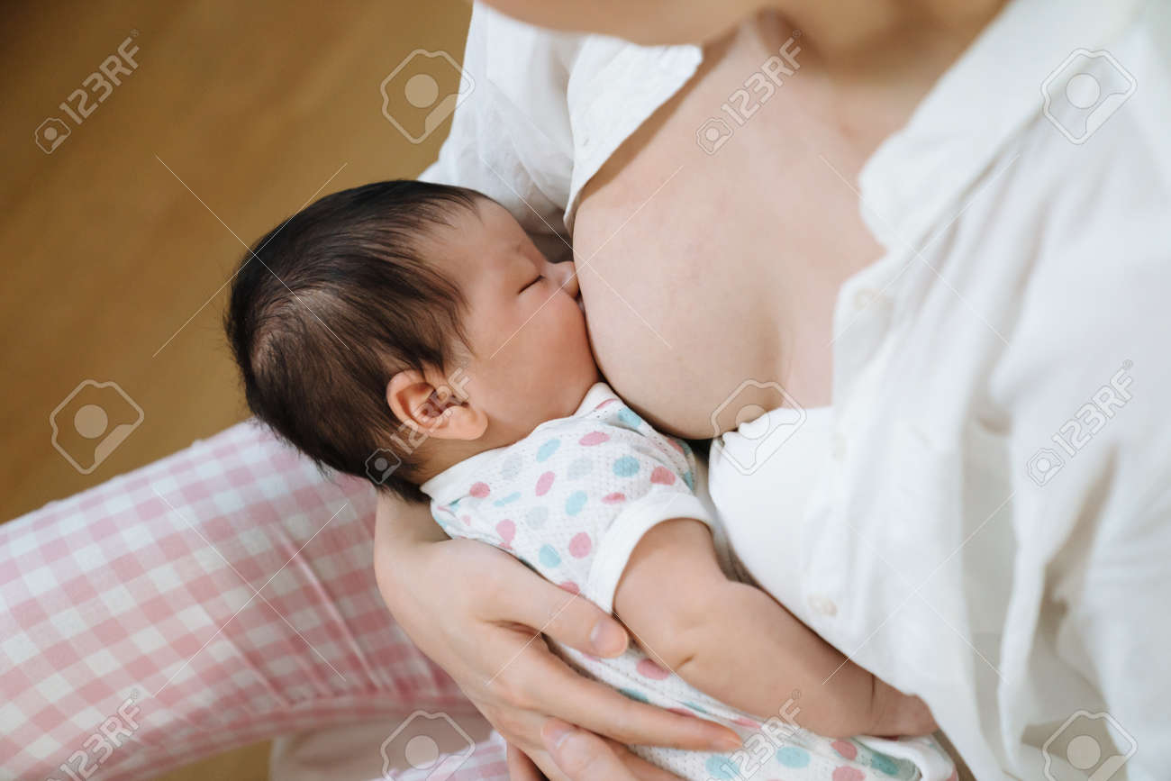 POV Shot Of Hungry Baby Being Fed With Breast Milk By Her Mother, Feeling  Secure. Cropped View Of Mummy Building An Attachment Bond With Her Daughter  Through Breastfeeding. Stock Photo, Picture and
