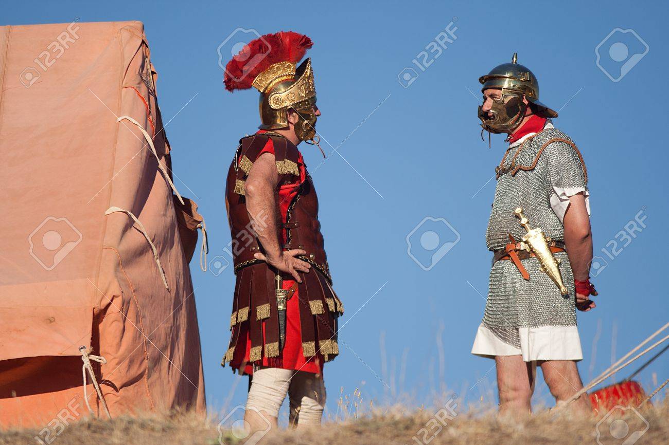 VALERIA, SPAIN - AUGUST 15: Unidentified performers dressed like roman soldiers are talking in a roman exhibition, in the ancient ruins of the roman city - 12469181 VALERIA, SPAIN - AUGUST 15: Unidentified performers dressed like roman soldiers are talking in a roman exhibition, in the ancient ruins of the roman city - 12469181