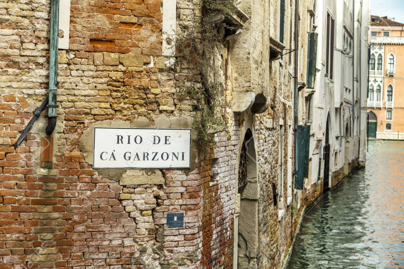 VENICE, ITALY - 25 August, 2018: View of the Rio de Garzoni Canal and brick wall of ancient building in Venice, Italy - 137706420 VENICE, ITALY - 25 August, 2018: View of the Rio de Garzoni Canal and brick wall of ancient building in Venice, Italy - 137706420