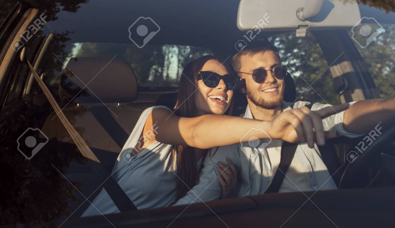 Loving couple travelling by car has noticed a nice place to stop and rest - 145147752 Loving couple travelling by car has noticed a nice place to stop and rest - 145147752