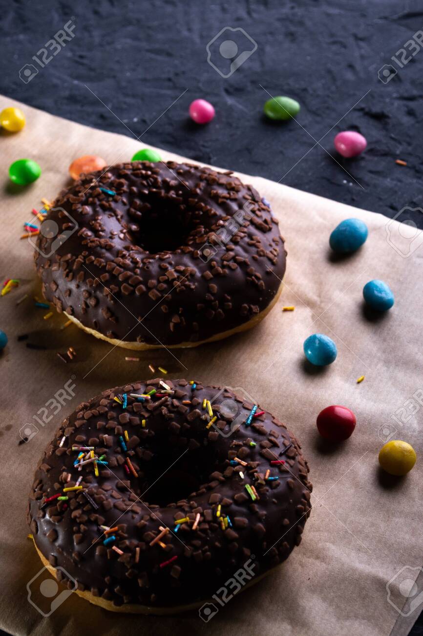 Donuts on a wooden board on a blue concrete background. - 151402407 Donuts on a wooden board on a blue concrete background. - 151402407