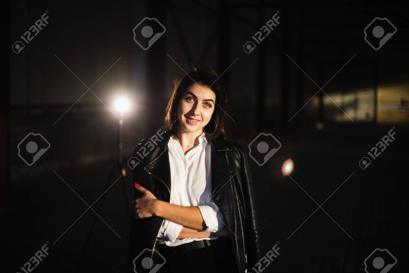 Girl in a leather jacket on an old abandoned construction site. - 155052825 Girl in a leather jacket on an old abandoned construction site. - 155052825