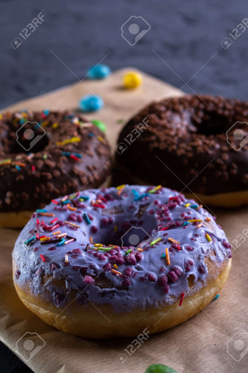 Donuts on a wooden board on a blue concrete background. - 154905328 Donuts on a wooden board on a blue concrete background. - 154905328