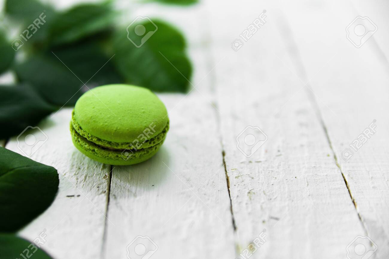Green macaroon food photo with green leaves. - 154904196 Green macaroon food photo with green leaves. - 154904196