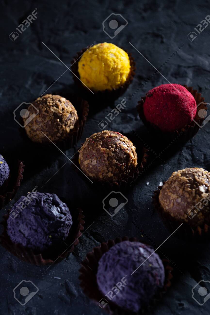 Colored round candies on a dark background. - 154905294 Colored round candies on a dark background. - 154905294
