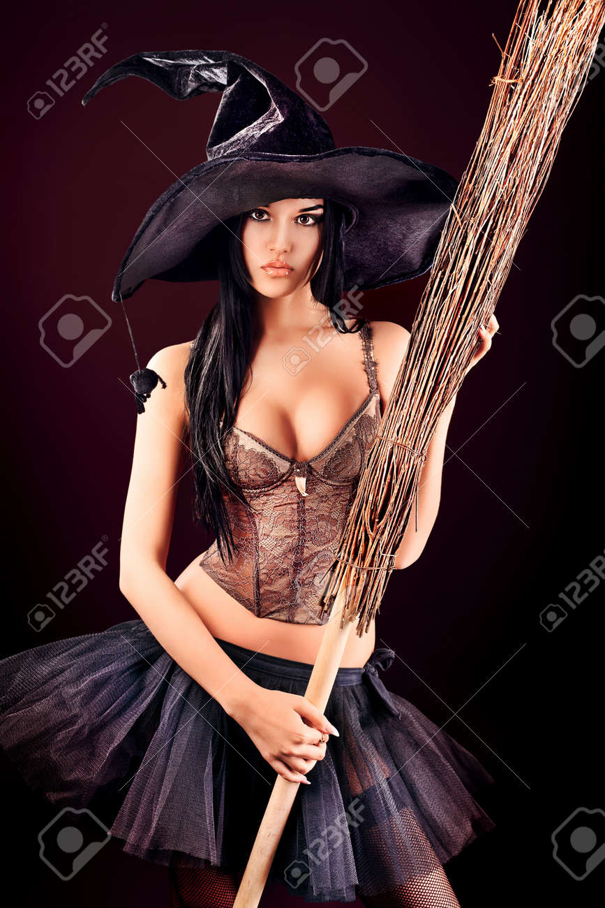 Charming halloween witch with broom over black background. - 13339620 Charming halloween witch with broom over black background. - 13339620