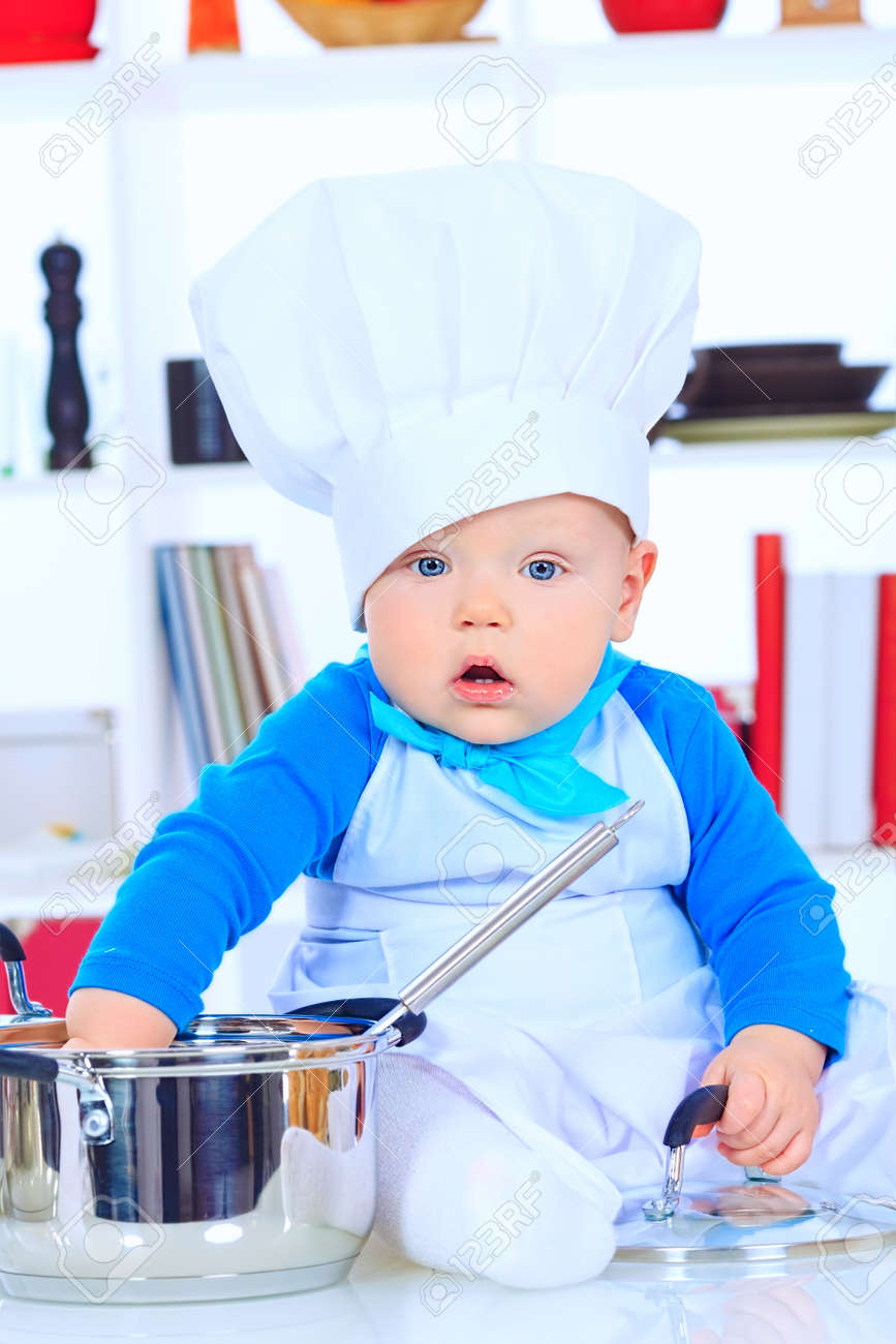 Cute Small Baby In The Cook Costume At The Kitchen Stock Photo Picture And Royalty Free Image Image 21199123