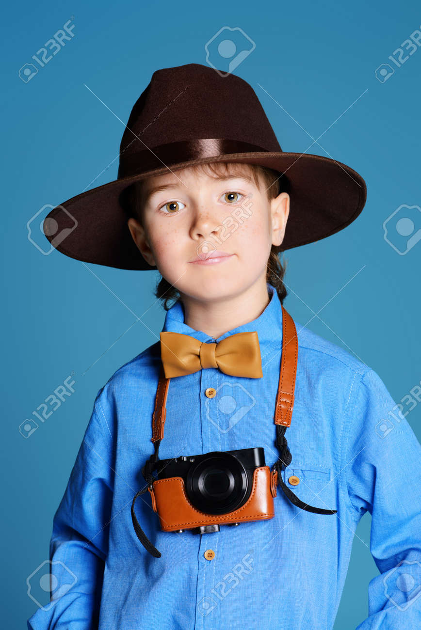 portrait of a cute 7 year old boy in elegant hat and bow tie stock