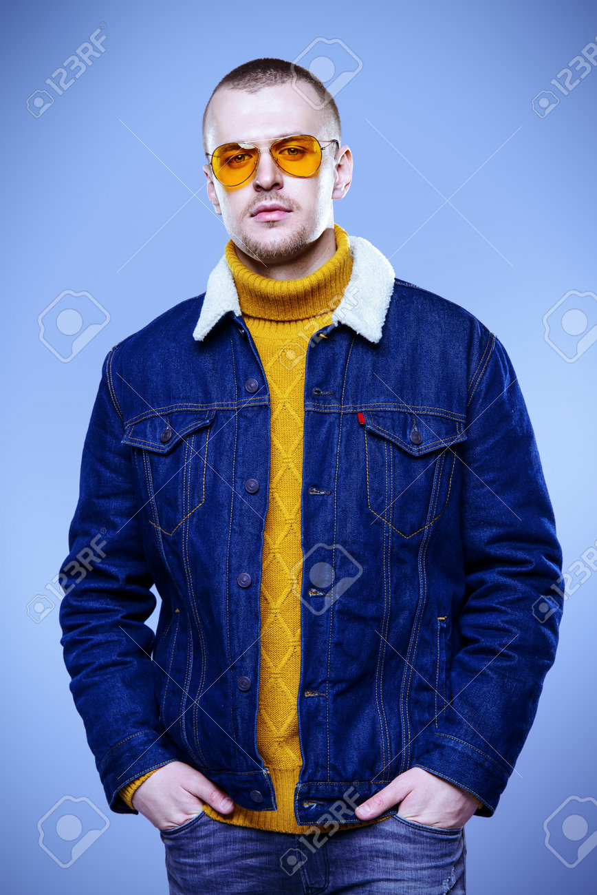 Sexual Male Model Posing In Jeans Clothes And Yellow Sunglasses