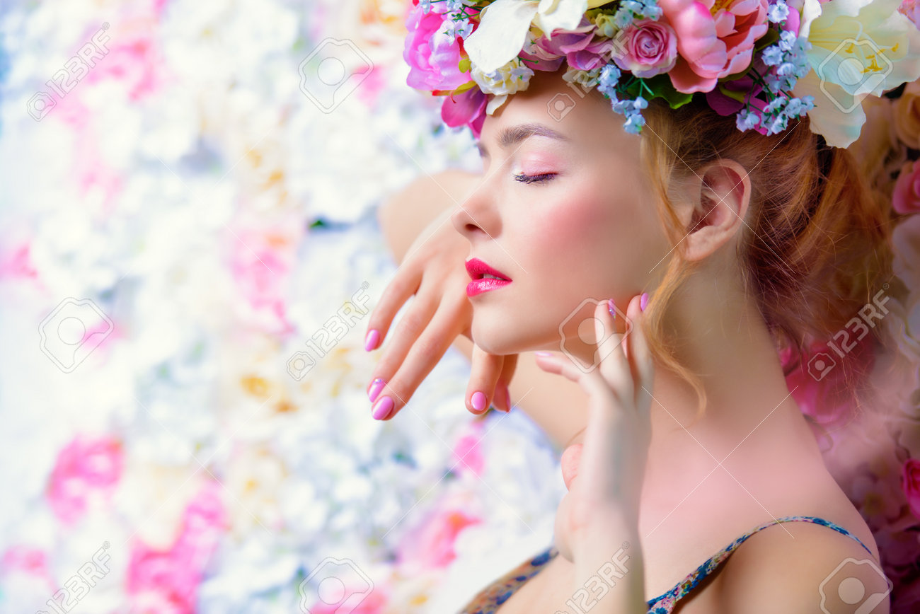 Beautiful romantic young woman in a wreath of flowers posing on a background of roses. Inspiration of spring and summer. Perfume, cosmetics concept. - 71506627 Beautiful romantic young woman in a wreath of flowers posing on a background of roses. Inspiration of spring and summer. Perfume, cosmetics concept. - 71506627