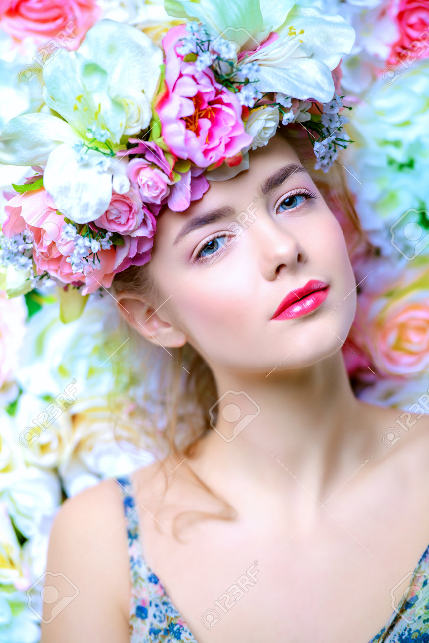 Beautiful romantic young woman in a wreath of flowers posing on a background of roses. Inspiration of spring and summer. Perfume, cosmetics concept. - 71505350 Beautiful romantic young woman in a wreath of flowers posing on a background of roses. Inspiration of spring and summer. Perfume, cosmetics concept. - 71505350