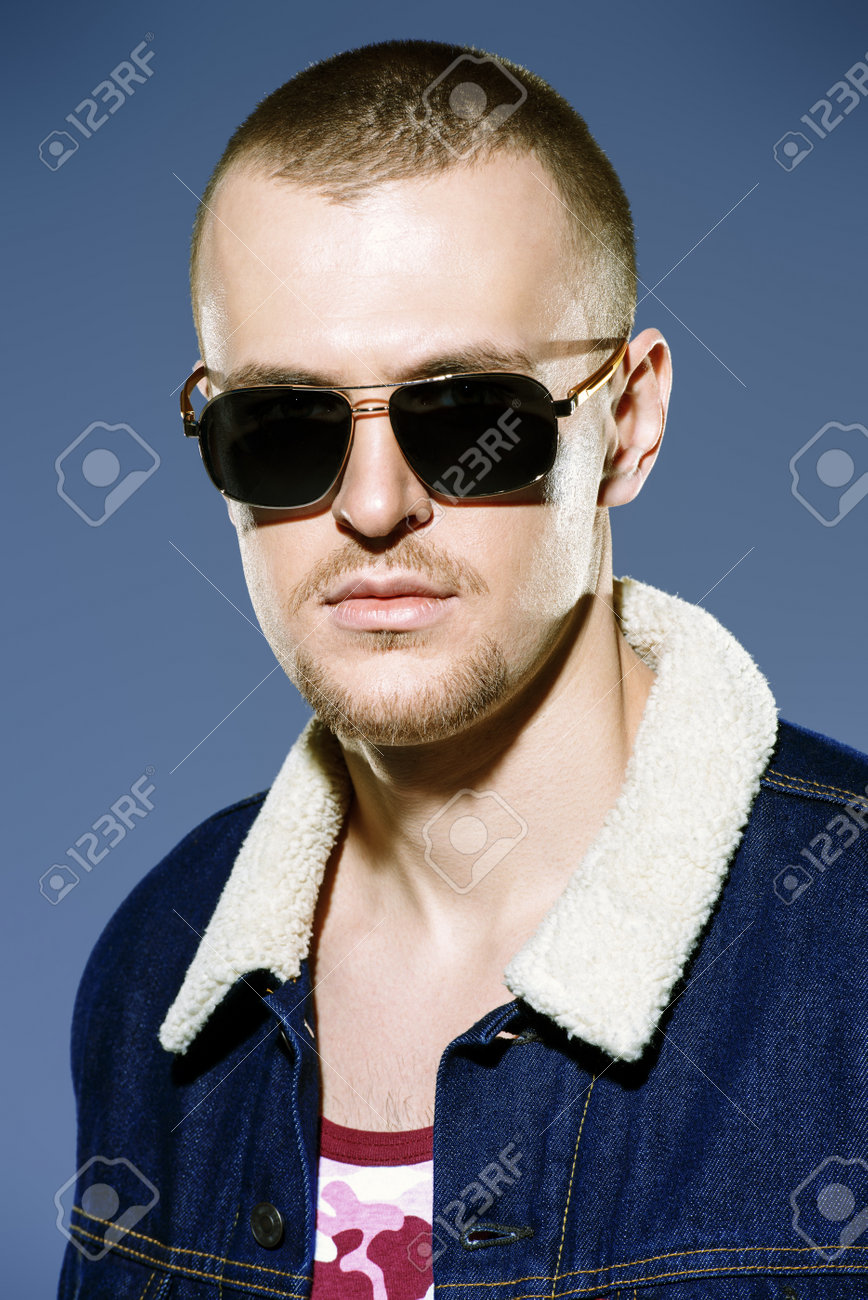 Sexual Male Model Posing In Jeans Clothes And Sunglasses Short
