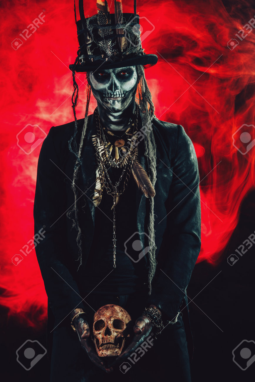 A man with a skull makeup dressed in a tail-coat and a top-hat. Baron Saturday. Baron Samedi. Dia de los muertos. Day of The Dead. Halloween. - 86130675 A man with a skull makeup dressed in a tail-coat and a top-hat. Baron Saturday. Baron Samedi. Dia de los muertos. Day of The Dead. Halloween. - 86130675