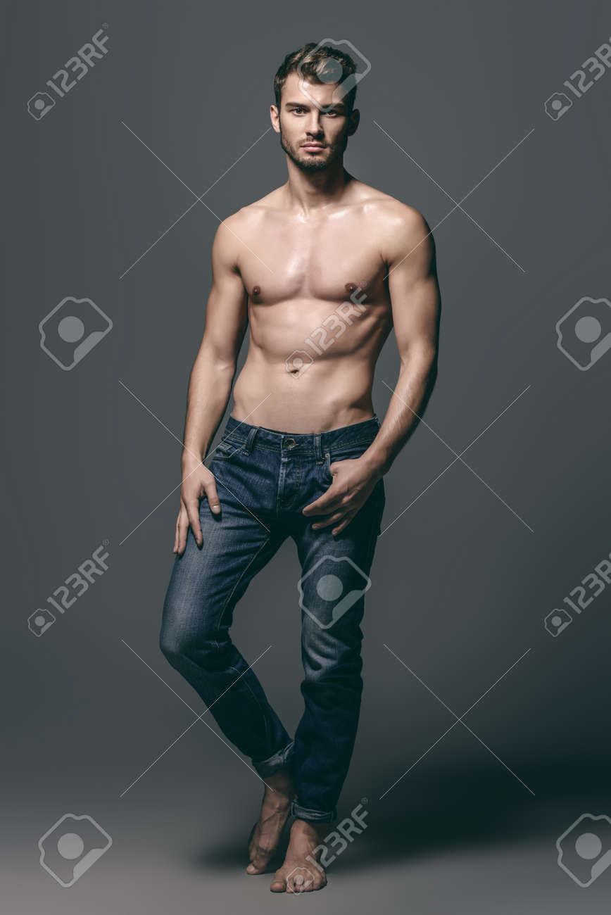 shirtless man in jeans