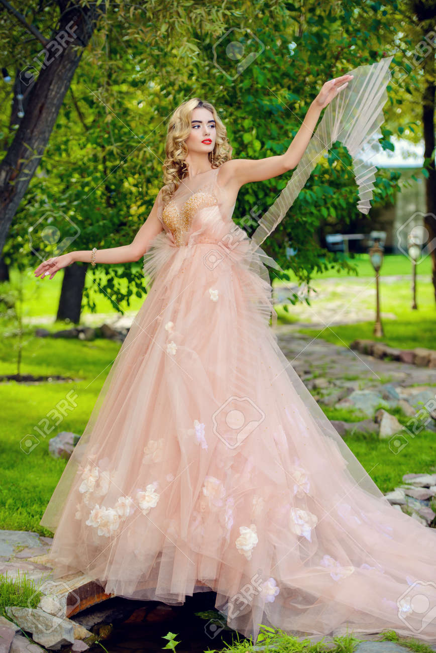 Charming bride girl in a beautiful wedding dress with lush skirt..