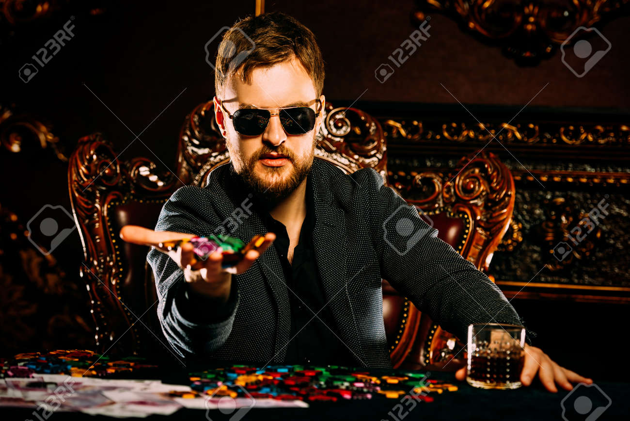 Wealthy man playing poker in a casino
